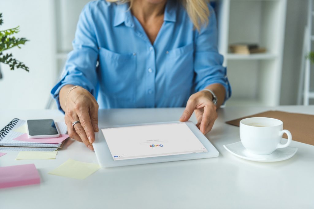 cropped view of businesswoman using digital tablet with Google website as a google review concept